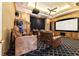 Home theater with projector, tiered seating, and custom millwork at 7915 Se 12Th Cir, Ocala, FL 34480