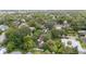 A beautiful aerial view of a home nestled among mature trees and lush landscaping at 828 Se 3Rd St, Ocala, FL 34471