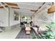 This covered porch offers a comfortable lounge area and dining space, ideal for outdoor living at 828 Se 3Rd St, Ocala, FL 34471