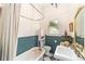 Charming bathroom with vintage-style fixtures, beadboard paneling, and checkered tile floor at 828 Se 3Rd St, Ocala, FL 34471