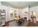 Bright dining room featuring a decorative chandelier, fireplace, area rug, and natural light from the windows at 828 Se 3Rd St, Ocala, FL 34471