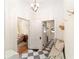 Inviting entryway with black and white tile floors, bench seating, and access to multiple rooms at 828 Se 3Rd St, Ocala, FL 34471