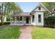 Charming home with brick walkway leading to a cozy porch with flower boxes, offering a warm and inviting ambiance at 828 Se 3Rd St, Ocala, FL 34471