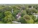 Aerial view of a charming home with a white picket fence and surrounded by mature trees at 828 Se 3Rd St, Ocala, FL 34471