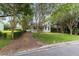 Charming home with lush greenery, featuring a quaint porch and a private driveway surrounded by mature trees at 828 Se 3Rd St, Ocala, FL 34471