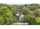 Aerial view of a charming two-story home featuring a cozy porch and well-manicured lawn at 828 Se 3Rd St, Ocala, FL 34471