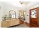Elegant foyer featuring hardwood floors, stylish decor, and a view into the living room at 828 Se 3Rd St, Ocala, FL 34471