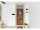 Charming stained wood front door with wreath and the house number displayed at 828 Se 3Rd St, Ocala, FL 34471