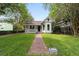 Charming home featuring a brick walkway, landscaped yard and welcoming front porch at 828 Se 3Rd St, Ocala, FL 34471