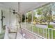 Cozy porch with a swing, ceiling fan, and flower boxes, offering a relaxing space to enjoy the neighborhood views at 828 Se 3Rd St, Ocala, FL 34471