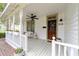 Inviting porch with a porch swing, flower boxes, and a stained wood front door at 828 Se 3Rd St, Ocala, FL 34471