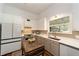 Spacious kitchen featuring modern appliances, white and gray cabinets, stylish backsplash, and countertop space at 828 Se 3Rd St, Ocala, FL 34471