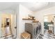 Functional laundry room featuring modern washer and dryer, with convenient access to a bathroom at 828 Se 3Rd St, Ocala, FL 34471