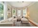 Bright living room featuring a comfortable sectional sofa, large windows, and hardwood floors at 828 Se 3Rd St, Ocala, FL 34471
