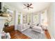 Cozy living room with large windows, comfortable sectional sofa, and hardwood floors at 828 Se 3Rd St, Ocala, FL 34471