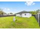 Exterior shot of home's backyard featuring lush green grass and fenced perimeter at 8456 Se 164Th Pl, Summerfield, FL 34491