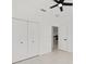 Bright bedroom featuring tile floors, ceiling fan, and closet doors at 8456 Se 164Th Pl, Summerfield, FL 34491