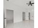 Bright bedroom with multiple doors, white tile floors, and ample closet space at 8456 Se 164Th Pl, Summerfield, FL 34491