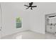 Bright bedroom featuring tile floors, ceiling fan, and en suite bath at 8456 Se 164Th Pl, Summerfield, FL 34491