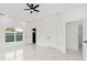 Bright primary bedroom featuring white tile floors, a ceiling fan, and abundant natural light at 8456 Se 164Th Pl, Summerfield, FL 34491