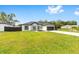 Charming single-story home with a manicured lawn, attached garage and modern architectural details at 8456 Se 164Th Pl, Summerfield, FL 34491
