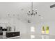 Open-concept living space with a central island, modern lighting, stainless steel appliances, and backyard access at 8456 Se 164Th Pl, Summerfield, FL 34491