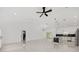 Spacious open-concept living room and kitchen area featuring white tile floors and modern finishes at 8456 Se 164Th Pl, Summerfield, FL 34491