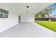 Covered patio with sliding glass doors and a view of the green backyard at 8456 Se 164Th Pl, Summerfield, FL 34491