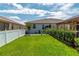 Residential backyard with well-kept lawn, trimmed hedges, privacy fence, and cozy gazebo at 9886 Sw 104Th Ave, Ocala, FL 34481