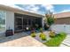 Backyard with a screened patio, stone pavers, manicured shrubbery and a privacy fence at 9886 Sw 104Th Ave, Ocala, FL 34481