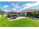 Expansive backyard with lush green lawn, paver patio, pergola, and manicured landscaping at 9886 Sw 104Th Ave, Ocala, FL 34481