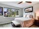 Serene bedroom with natural light, wood-look tile flooring, and stylish decor at 9886 Sw 104Th Ave, Ocala, FL 34481