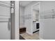 Walk-in closet with wire shelving and a laundry room with a washer and dryer beyond the doorway at 9886 Sw 104Th Ave, Ocala, FL 34481