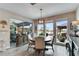 Bright dining area with modern pendant lighting, large windows, and seamless access to the outdoor area at 9886 Sw 104Th Ave, Ocala, FL 34481