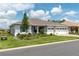 Beautiful single-story home with a well-manicured lawn, three-car garage, and lush landscaping at 9886 Sw 104Th Ave, Ocala, FL 34481
