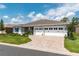 Charming single-story home with a three-car garage, brick-paved driveway, and beautifully landscaped yard at 9886 Sw 104Th Ave, Ocala, FL 34481