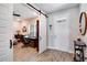 Welcoming home office with wood-look tile flooring, natural light, and sliding barn door for added privacy at 9886 Sw 104Th Ave, Ocala, FL 34481