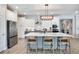 Stylish kitchen boasting a large island, stainless steel appliances, pendant lighting, and ample cabinet space at 9886 Sw 104Th Ave, Ocala, FL 34481