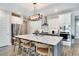 Modern kitchen features an island with seating, white cabinets, and stainless steel appliances at 9886 Sw 104Th Ave, Ocala, FL 34481
