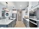 Well-equipped kitchen with stainless steel appliances, center island, and sleek gray and white cabinetry at 9886 Sw 104Th Ave, Ocala, FL 34481