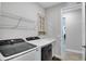 Functional laundry room equipped with modern front load washer and dryer, sink, and ample storage at 9886 Sw 104Th Ave, Ocala, FL 34481
