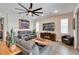 Relaxing living room featuring a fireplace and large, modern ceiling fan at 9886 Sw 104Th Ave, Ocala, FL 34481