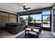 Screened-in patio with comfortable seating, hot tub, ceiling fan, and a view to the outdoor area at 9886 Sw 104Th Ave, Ocala, FL 34481