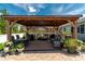 Inviting backyard pergola with outdoor kitchen, dining, and seating areas on paver patio at 9886 Sw 104Th Ave, Ocala, FL 34481