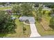 Well-maintained single-story home on a spacious lot with a large lawn, mature trees, and a long driveway at 106 Pine Trce, Ocala, FL 34472