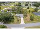 Aerial view of the home featuring mature trees and a long driveway at 106 Pine Trce, Ocala, FL 34472
