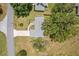 An aerial view of a well-maintained house, showcasing the roof, driveway, and surrounding mature trees at 106 Pine Trce, Ocala, FL 34472