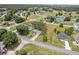An aerial view of the home and surrounding neighborhood shows a community with mature trees at 106 Pine Trce, Ocala, FL 34472