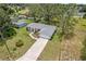 Aerial view of the house showcasing the well-maintained lawn, mature landscaping, and attached two-car garage at 106 Pine Trce, Ocala, FL 34472