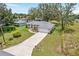 Aerial shot displaying house with driveway, spacious front yard and well-maintained landscaping at 106 Pine Trce, Ocala, FL 34472